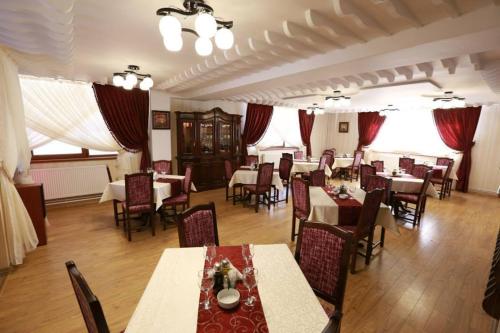 een restaurant met tafels en stoelen in een kamer bij Class in Petroşani