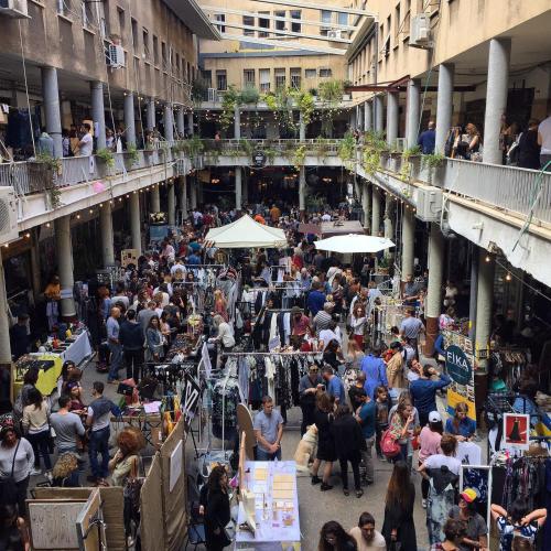 a crowd of people walking around a market in a building at Link Hotel & Hub By Dan Hotels in Tel Aviv