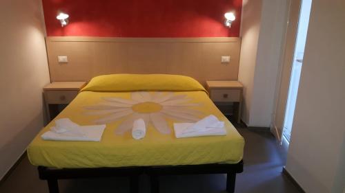 a bed in a room with a white bedspread at Hotel La Zorza in Riomaggiore