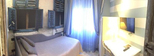 a bedroom with a bed and a sink and a window at Da ö Vittorio SRL in Recco
