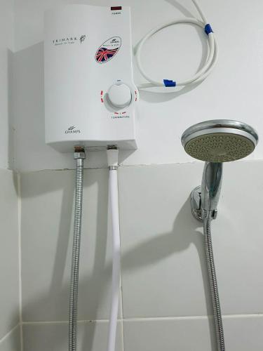 a shower in a bathroom with a machine on the wall at Cityscape Residences Unit 510 in Bacolod