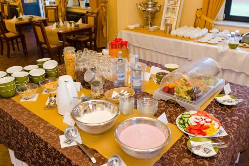 a table with bowls and plates of food on it at Elbe Resort Alte Ölmühle in Wittenberge