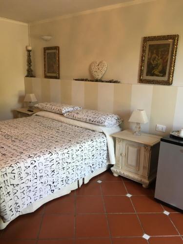 a bedroom with a bed and a side table at B&B Il Portico in Sarzana
