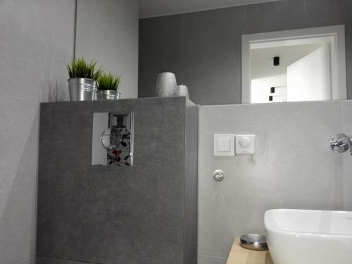 a bathroom with a sink and a mirror at Caroline Street nine in Katowice