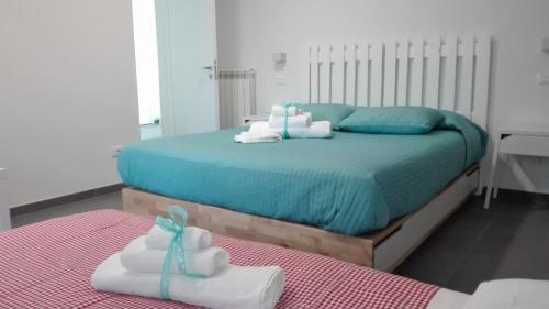 a bedroom with a bed with towels on it at Tivoli ShortLets - Catania in San Gregorio di Catania
