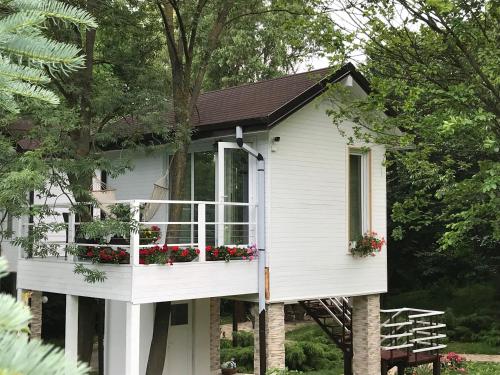 a white house with flower boxes on it at Rapsodia Pension in Suceava