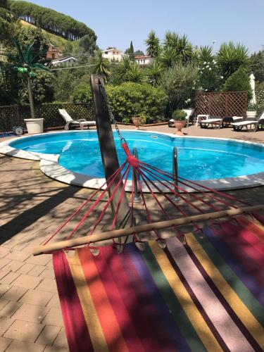 a group of wooden paddles next to a swimming pool at B&B Etna House in Nicolosi