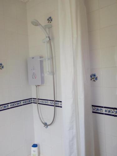 a shower in a bathroom with a shower curtain at Homestay, Number 29, Dunollie in Oban