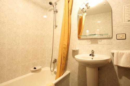 a bathroom with a sink and a toilet and a shower at Hostal San Roque in Portonovo