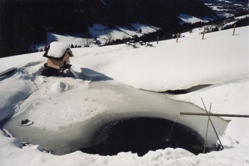 a hole in the snow with a house in it at Boabauer in Tamsweg