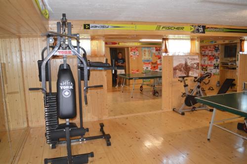 a room with a gym with a treadmill at Penzion 409 in Horní Branná