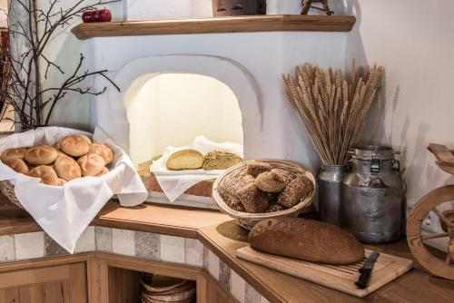 a table with bread and other foods on it at Hotel Riedl in Kössen