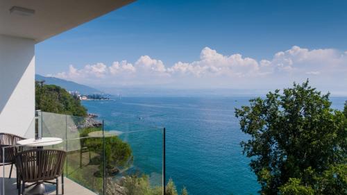 a view of the ocean from a house at Boutique Hotel Acacia in Lovran