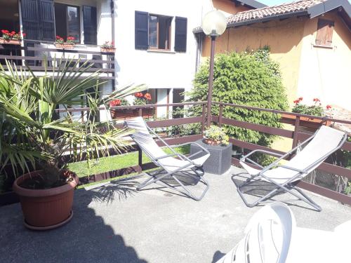 a pair of chairs sitting on a patio at Da Mara Lago Di Como in Sormano