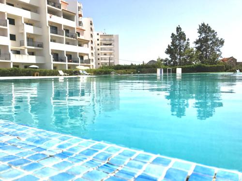 an empty swimming pool in front of a building at Laukamao Mar a Vista in Portimão