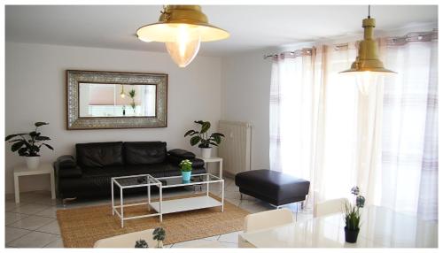 a living room with a black couch and a table at DOUBLE Two Lodge in Kappel-Grafenhausen