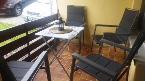 a small table and chairs on a balcony at Ferienwohnung Jesper in Braunlage