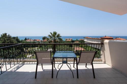 a patio with a table and chairs on a balcony at Katerina's Garden Mola Kaliva in Mola Kalyva