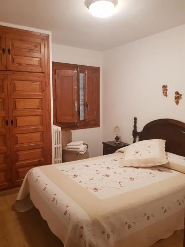 a bedroom with a bed and a wooden cabinet at Casa Simón in Roda de Isábena