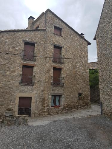 an old brick building with windows and balconies at Casa Simón in Roda de Isábena