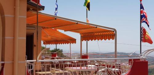 a group of tables and chairs under orange umbrellas at B&B da Pietro in Calascibetta
