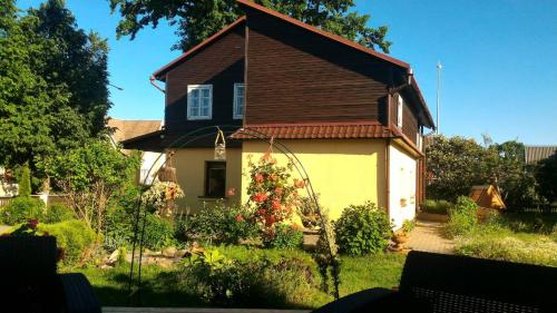 a small house with a brown roof at Prie Ąžuolo in Zarasai
