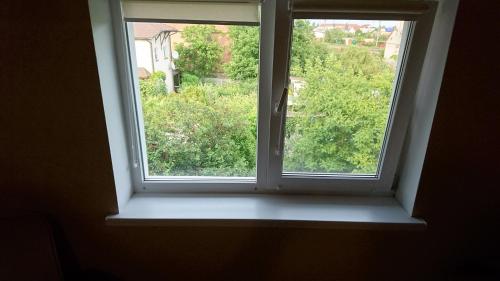 a window with a white sill in a room at Guest House Dacha in Karolino-Buhaz