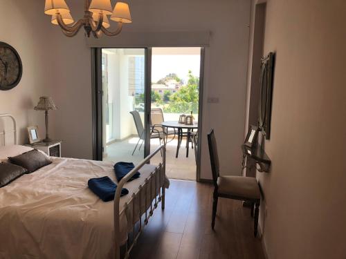 a bedroom with a bed and a dining room with a table at Gardenia 104 Near The Beach in Limassol