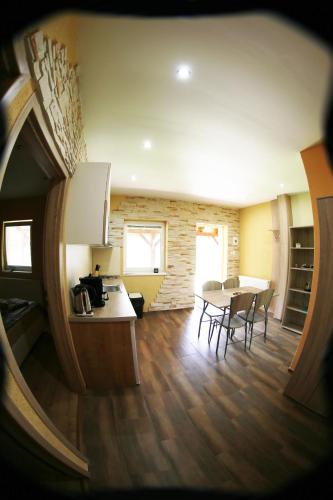 a kitchen and dining room with a table and chairs at Apartmány Dimitra in Štúrovo