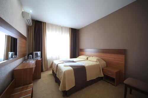 a hotel room with a bed and a window at Malaya Bukhta Health Resort in Anapa