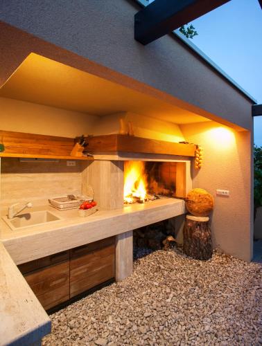 a kitchen with a fireplace in a house at Villa Lukić in Makarska