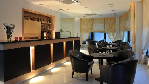 a bar with black chairs and tables in a restaurant at Royiatiko Hotel in Nicosia