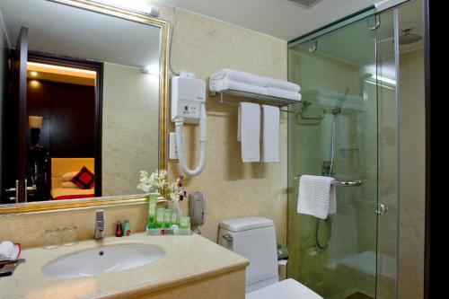 a bathroom with a sink and a glass shower at INNOTEL BATON ROUGE - A Luxury Collection Hotel in Dhaka