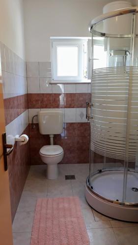 a bathroom with a toilet and a shower and a sink at Apartment Ivo in Trogir