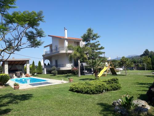 a villa with a swimming pool and a house at Villa Oneiro in Kanali