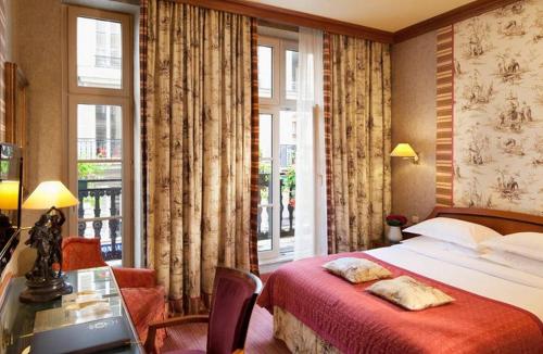 a hotel room with a bed and a window at Hôtel Horset Opéra, Best Western Premier Collection in Paris
