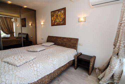 a bedroom with a bed and a mirror at Arunes Apartments - Daukanto in Palanga