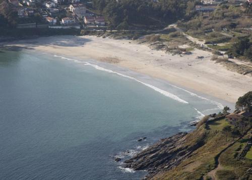 an aerial view of a beach and the ocean at Hostal San Roque in Portonovo
