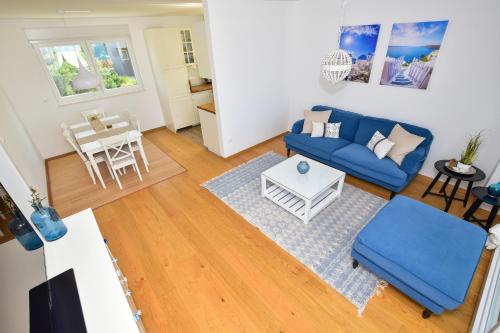 a living room with a blue couch and a table at Apartment Ricca Seaview in Makarska