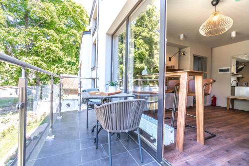 a room with a balcony with a table and chairs at Tamara Suites & Apartments in Jūrmala