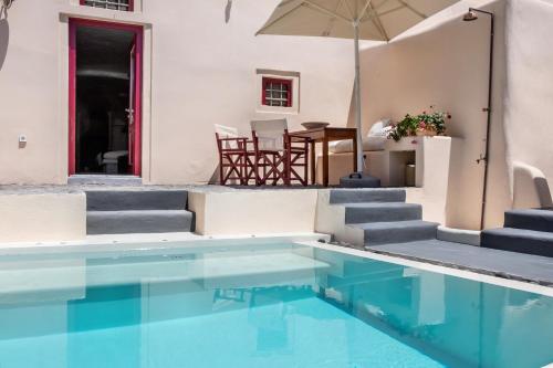 a pool with stairs and a table and chairs at Abelis Canava Luxury Suites in Vóthon
