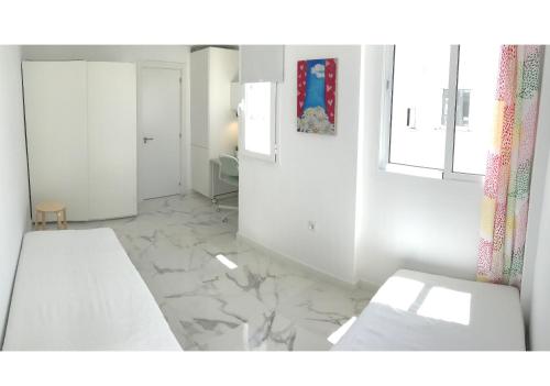 a white room with white walls and marble floors at New central 2BR apartment 100m-to-beach free parking in Fuengirola