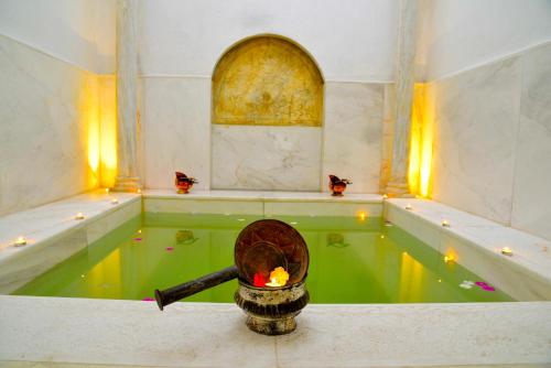 a swimming pool with a candle in the middle at Palais Bayram in Tunis