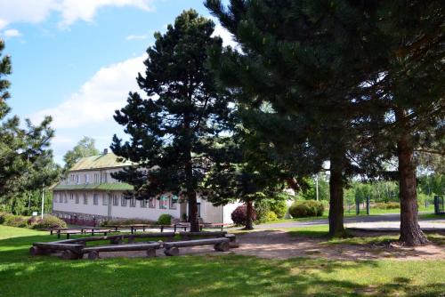 a group of benches in front of a building at Jcamp in Nové Město pod Smrkem