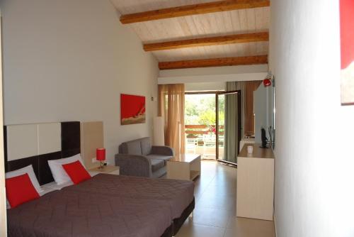 a bedroom with a bed and a living room at Medusa Lux Apartments in Liapades