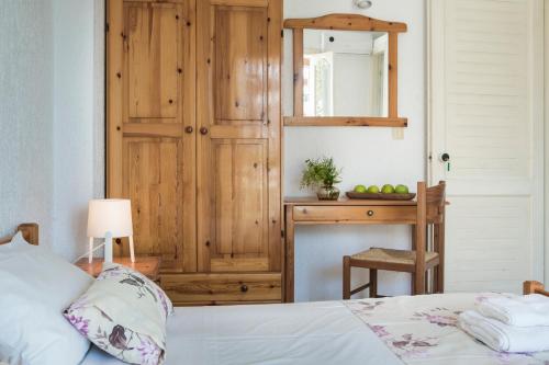 a bedroom with a bed and a table with a mirror at Sunset Beach Appartments in Minia
