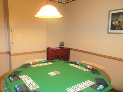 a room with a poker table with acesces at Alpine Log Cabin in Boone