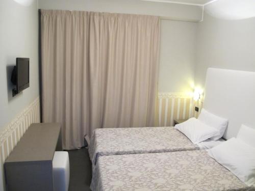 a small hotel room with a bed and a desk at Hotel Laguna Residence in Marghera