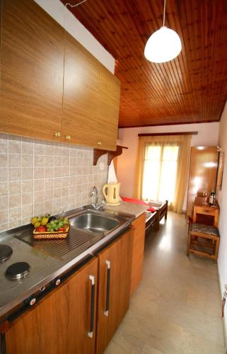 a kitchen with a sink and a counter top at Romeo & Juliet in Perivólion