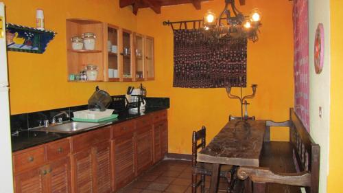 a kitchen with a sink and a table in it at Casa Hagan in Santa Cruz La Laguna
